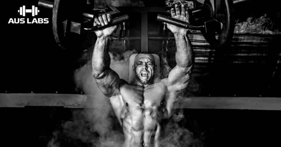 Muscular man lifting dumbbells on incline bench with AUS LABS logo and MYO (YK-11) product featured.